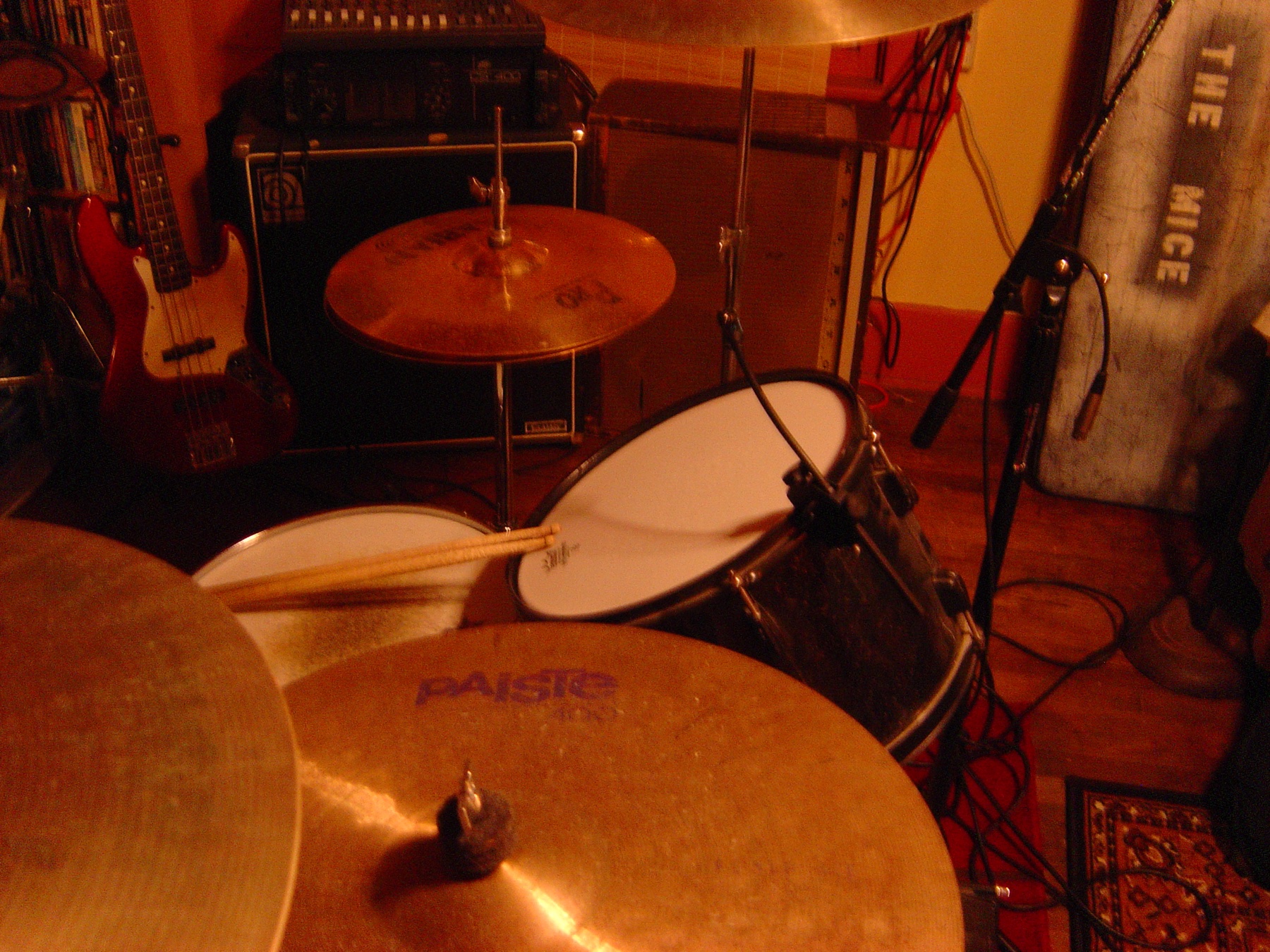 Behind the drum kit in the practice room